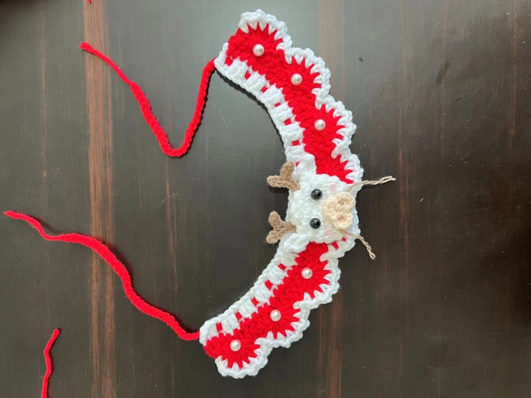 Knitted wool pet scarf with Christmas designs including striped Santa Claus pattern