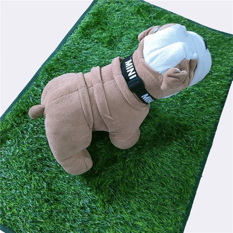 Green washable dog grass pee pad with realistic lawn texture on a patio.