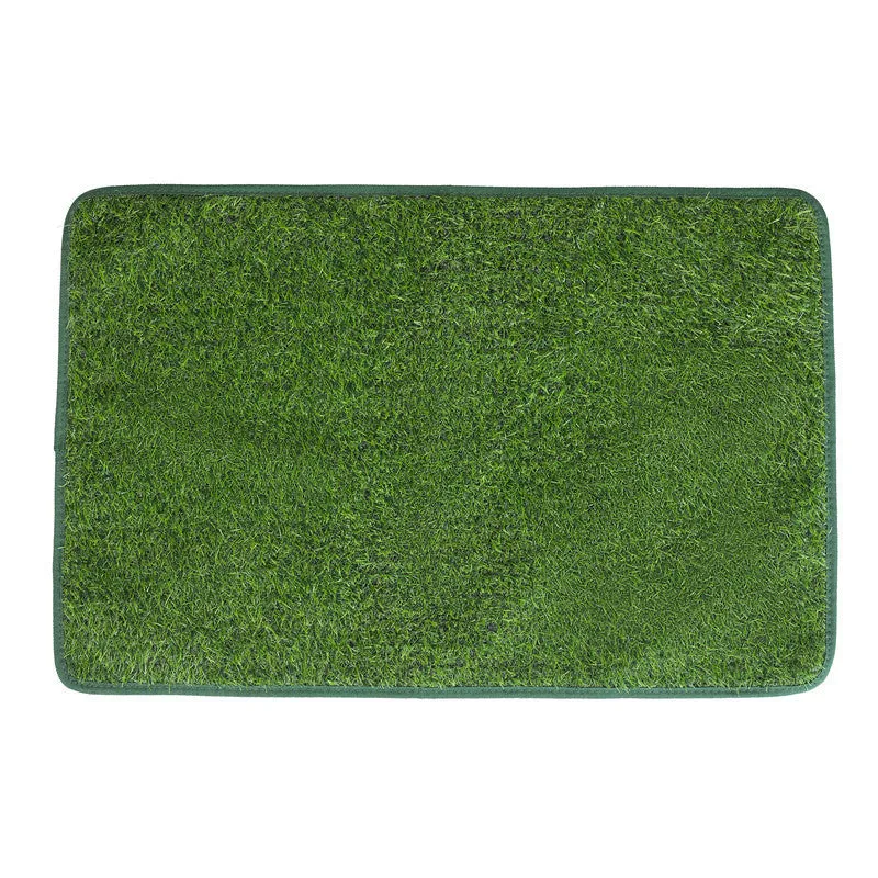 Green washable dog grass pee pad with realistic lawn texture on a patio.