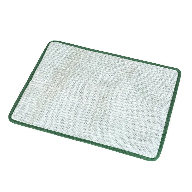 Green washable dog grass pee pad with realistic lawn texture on a patio.