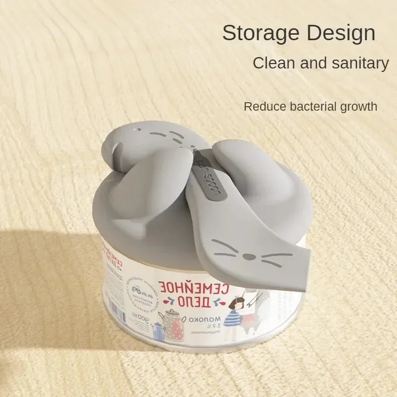 Grey, pink, and yellow silicone pet food spoon and lid sets with integrated can opener.