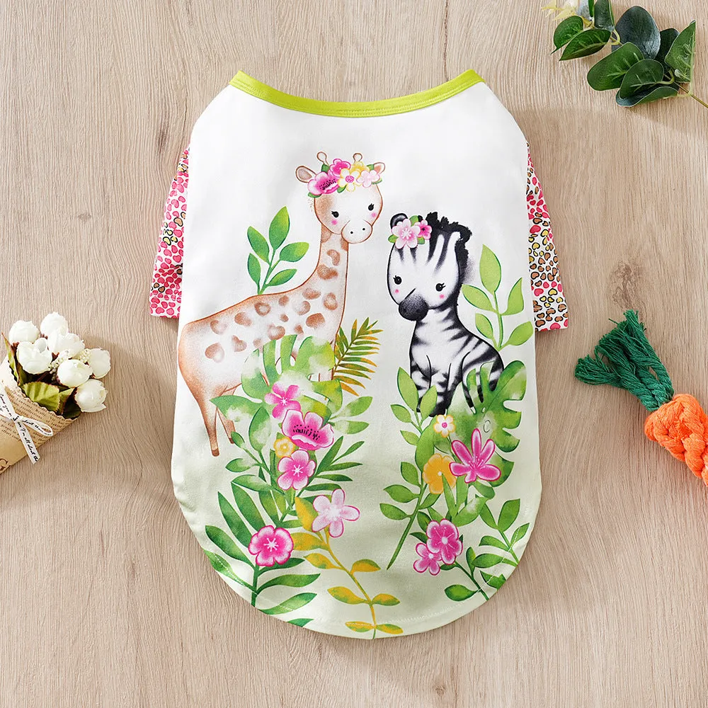 A small dog wearing a colourful, printed polyester t-shirt, showing the full chest design and fit.