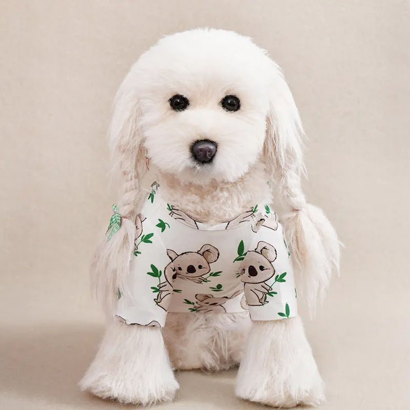 A small dog wearing a colourful, printed polyester t-shirt, showing the full chest design and fit.
