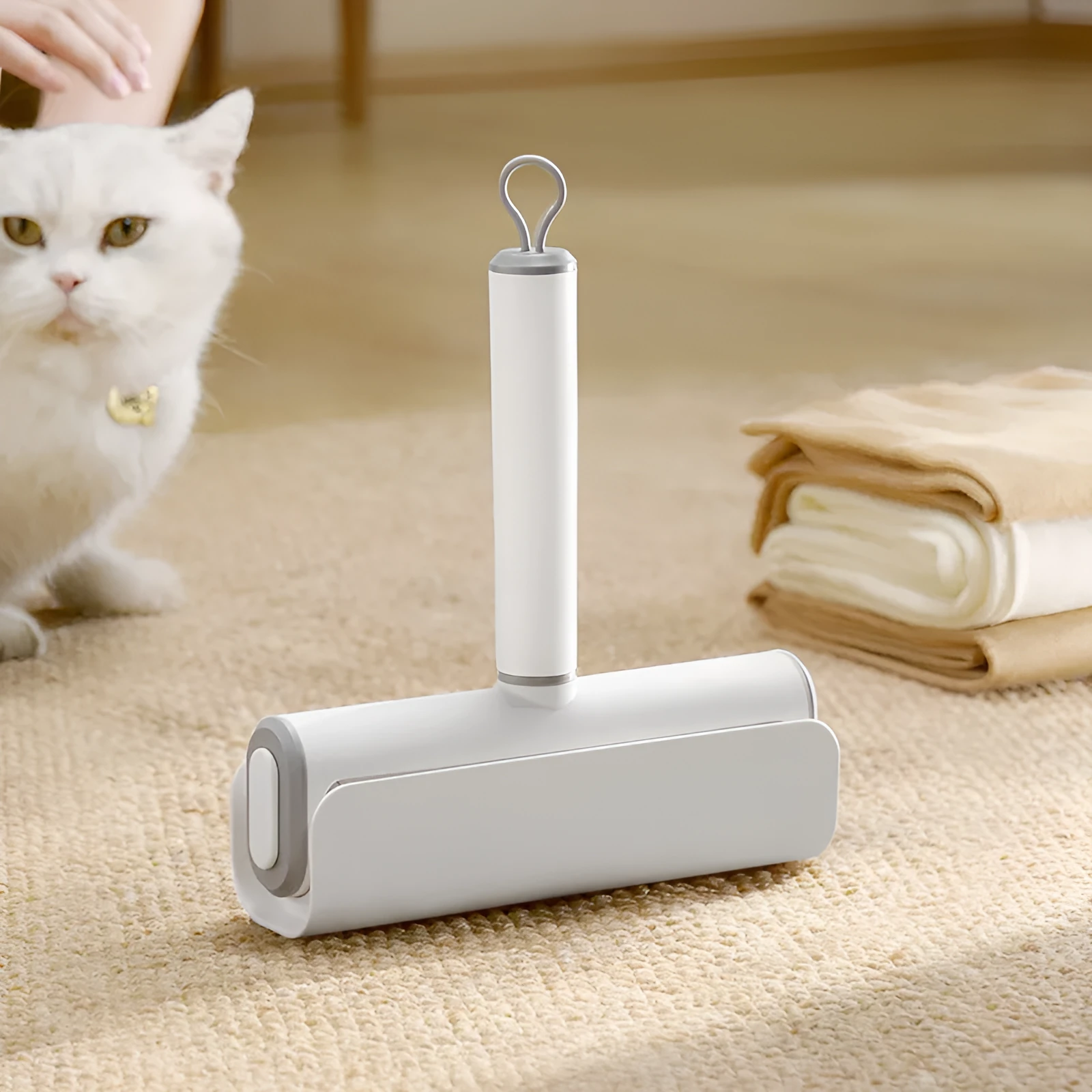 Handheld lint remover roller for pet hair removal on floors with tearable paper stick.