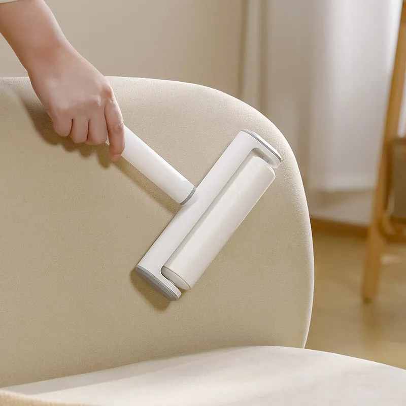 Handheld lint remover roller for pet hair removal on floors with tearable paper stick.