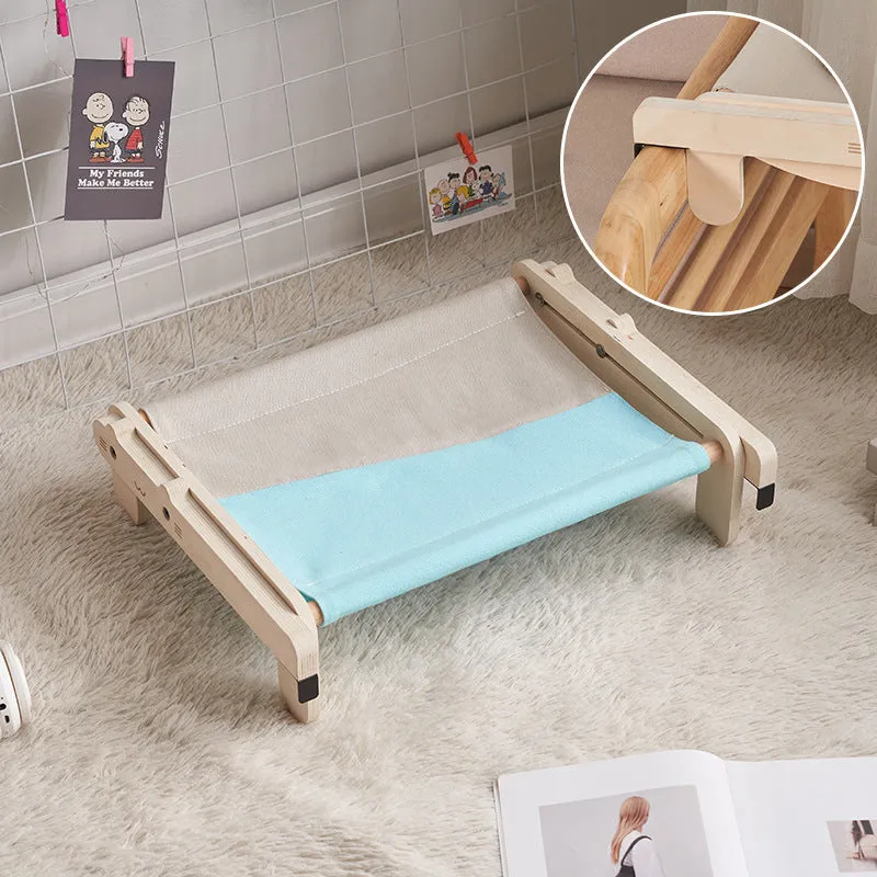 Solid wood cat bed with washable cover in grey-blue colour option on floor