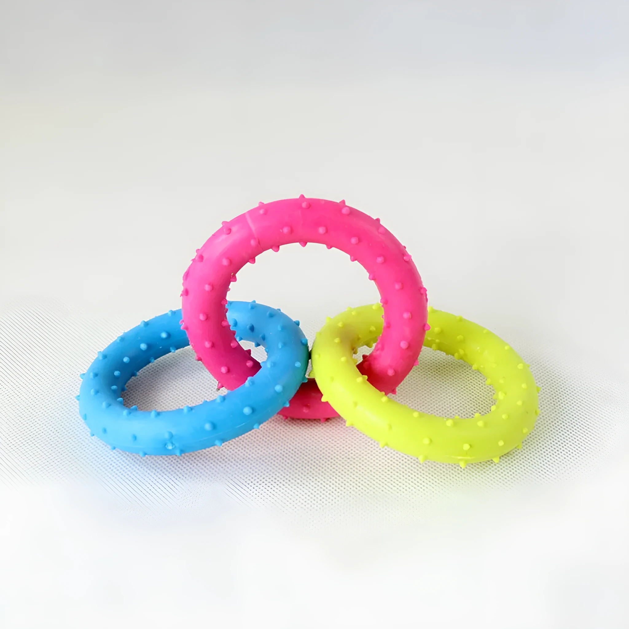 Three-chain TPR rubber dog molar toy for aggressive chewers shown in random colour
