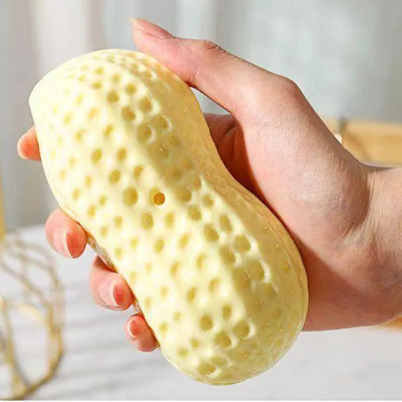 Yellow peanut-shaped dog chew toy with textured shell for teeth cleaning