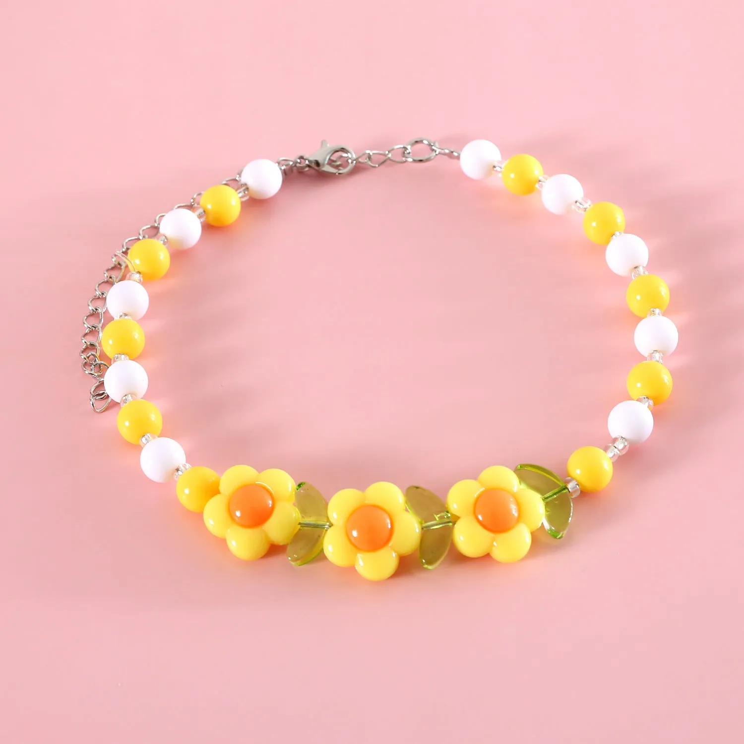 Colourful plastic pearl necklace for small pets on a white background, showing peach, rainbow, and small flower bead design options.