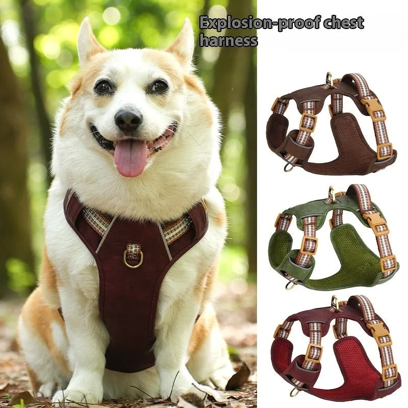 Brown leather dog harness with reflective strips and D-ring attachment on wooden background