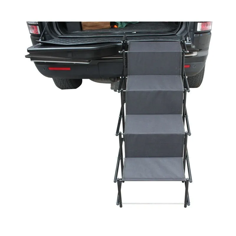 Folding stainless steel pet dog ladder in open position, showing steps, against a car boot.
