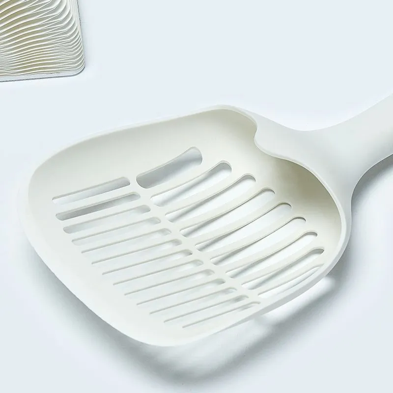 White plastic cat litter scoop with storage base for containing tool between uses