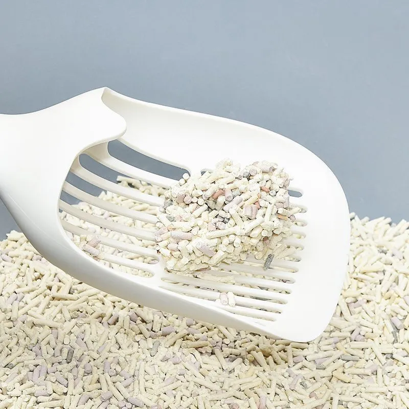 White plastic cat litter scoop with storage base for containing tool between uses