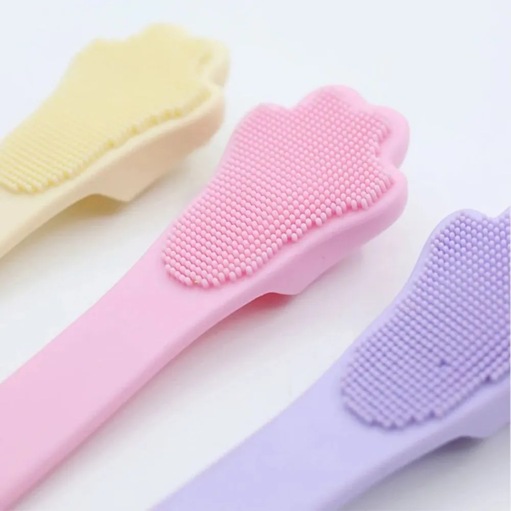 Silicone finger cover toothbrush for dogs and cats in pink, purple, yellow, and white.
