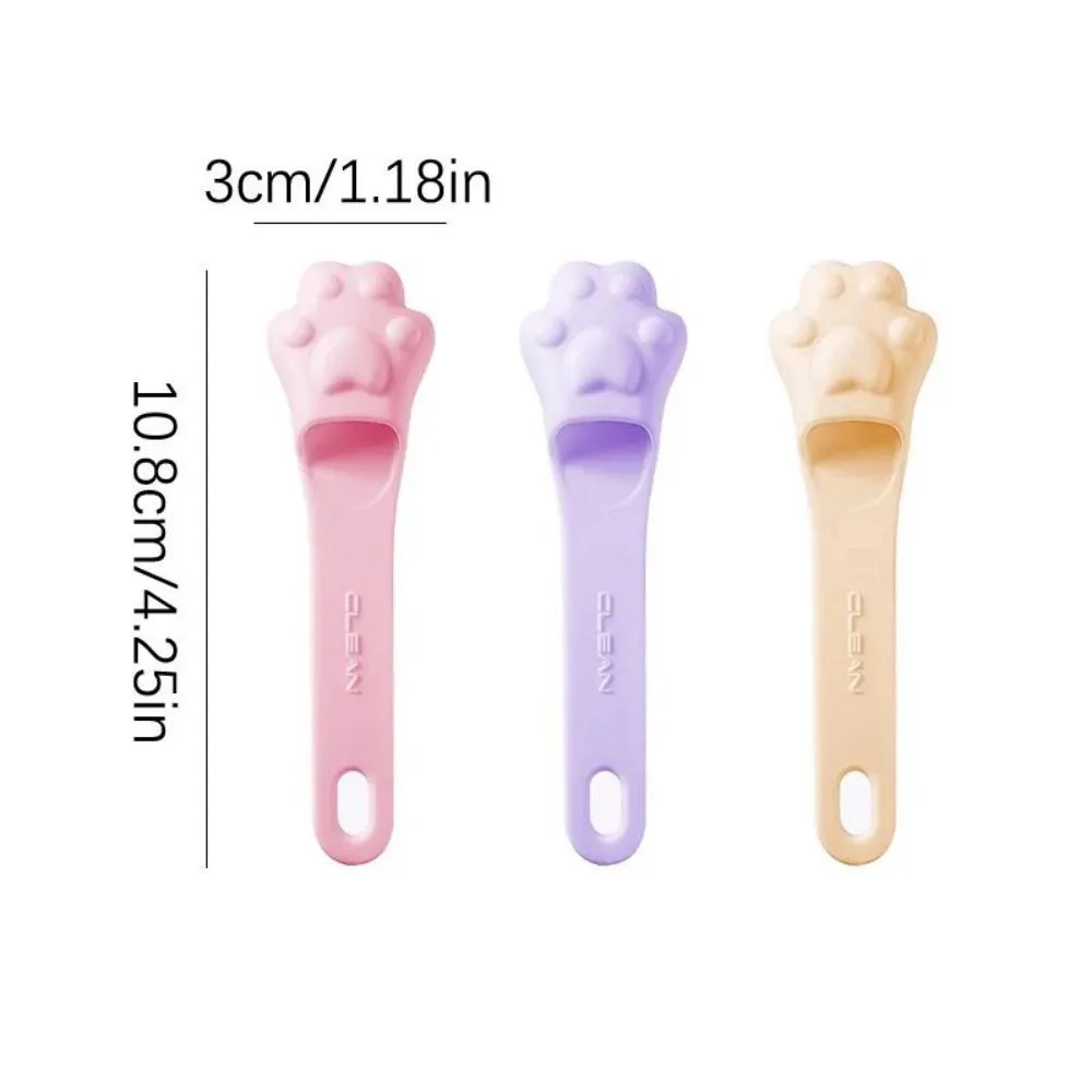 Silicone finger cover toothbrush for dogs and cats in pink, purple, yellow, and white.