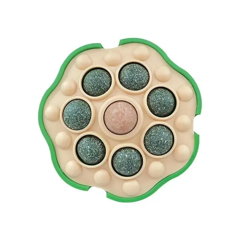 Green wall-sticking catnip ball with edible filling for indoor feline play and dental care