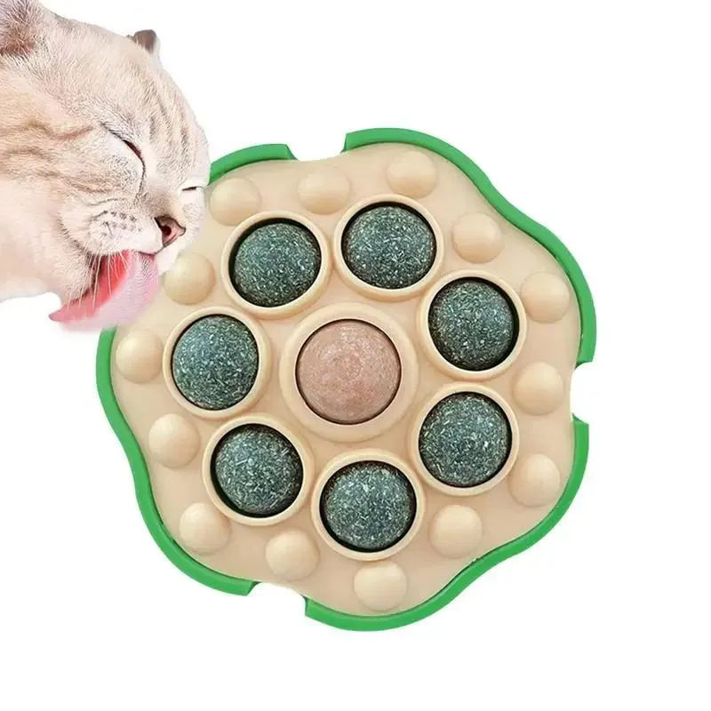 Green wall-sticking catnip ball with edible filling for indoor feline play and dental care
