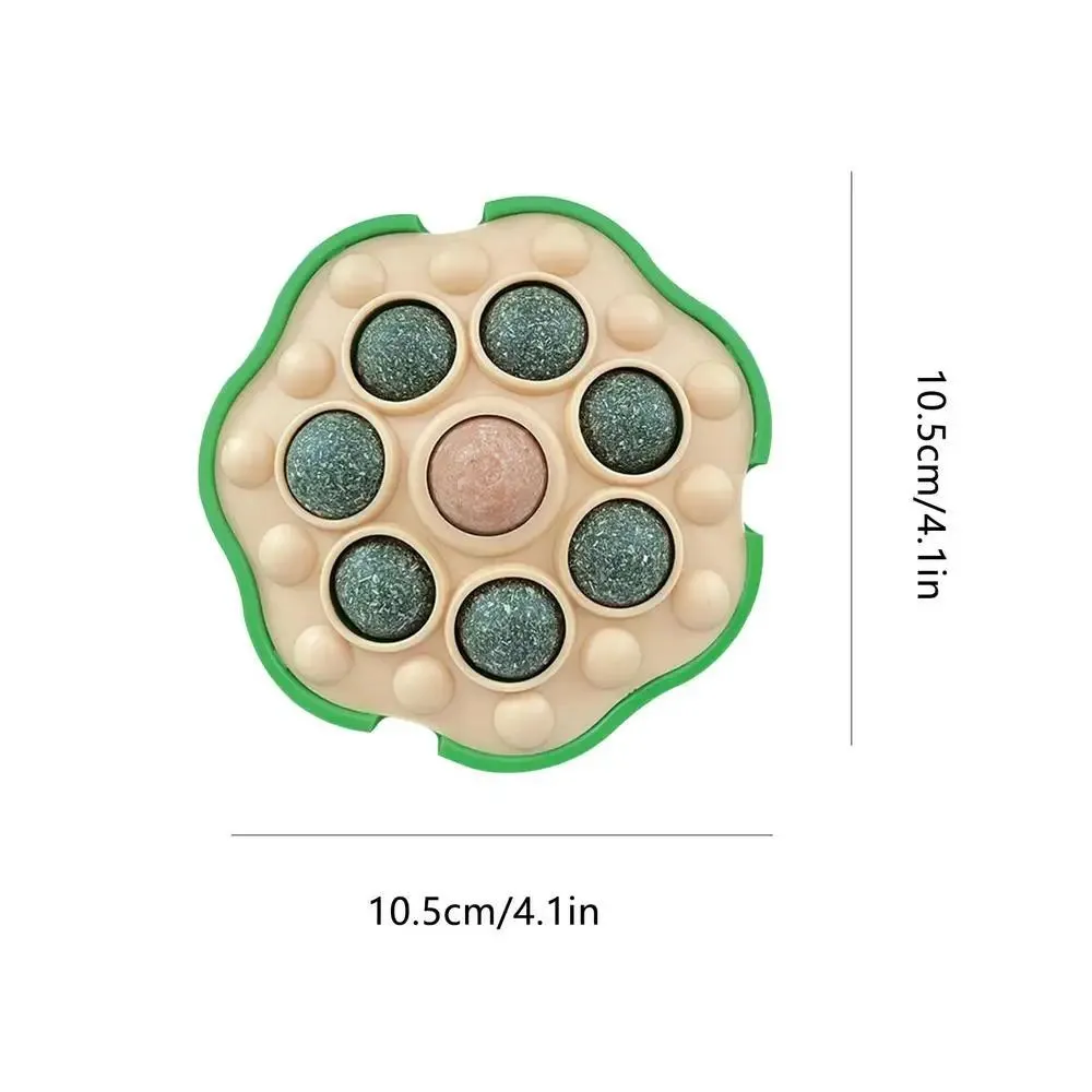 Green wall-sticking catnip ball with edible filling for indoor feline play and dental care