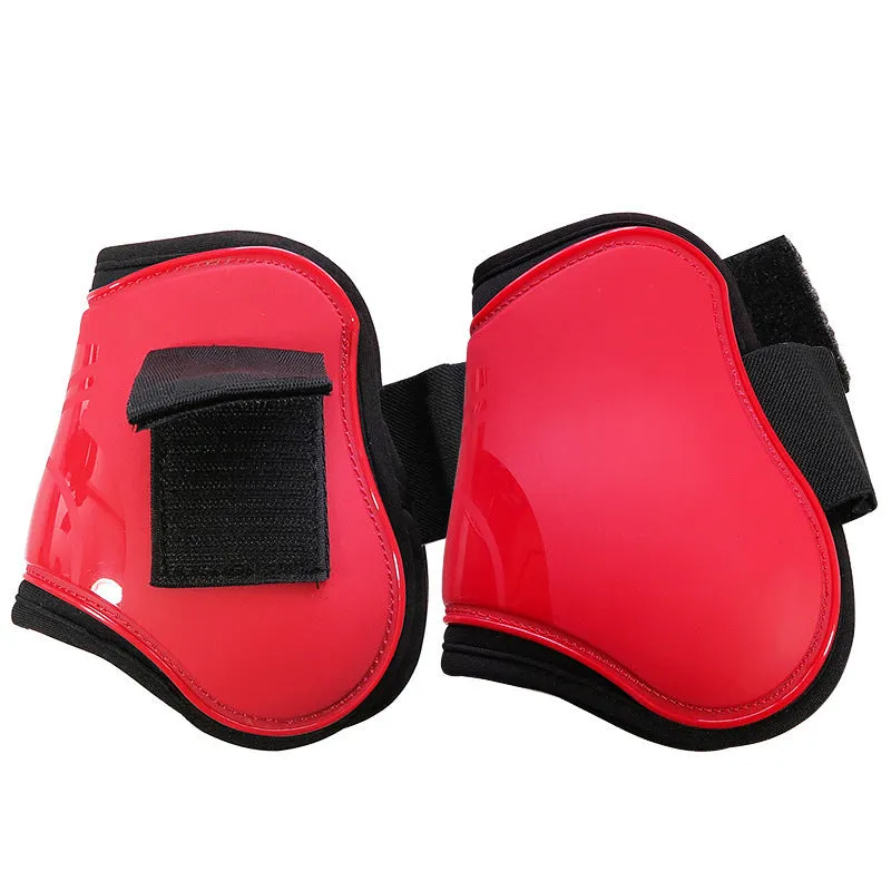 Horse leg guards in PU diving material, close-up on a front leg guard showing red colour and padded construction