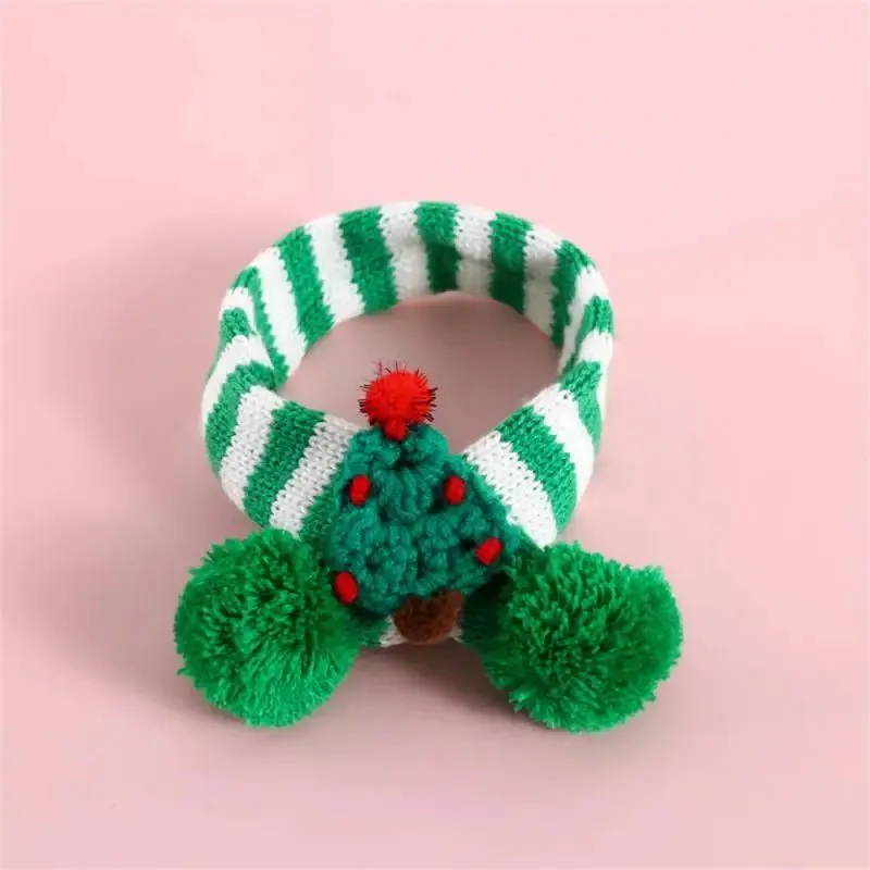Green adjustable knitted scarf collar for a small dog on a white background