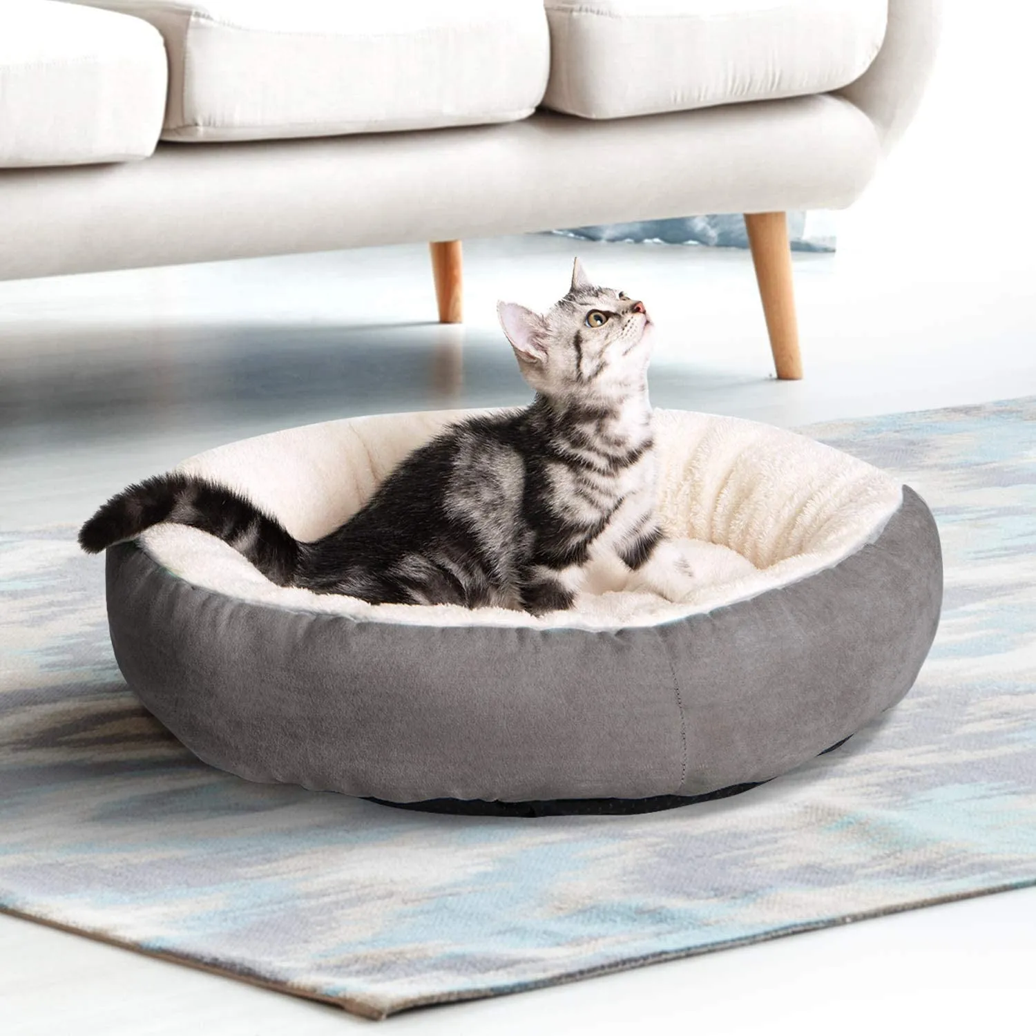Circular soft cloth pet bed nest in blue colour showing raised edges and nesting area