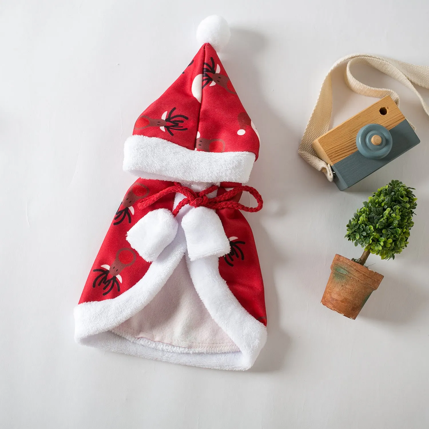Red deer-print Christmas cloak cape on a cat, showing Little Red Riding Hood style.