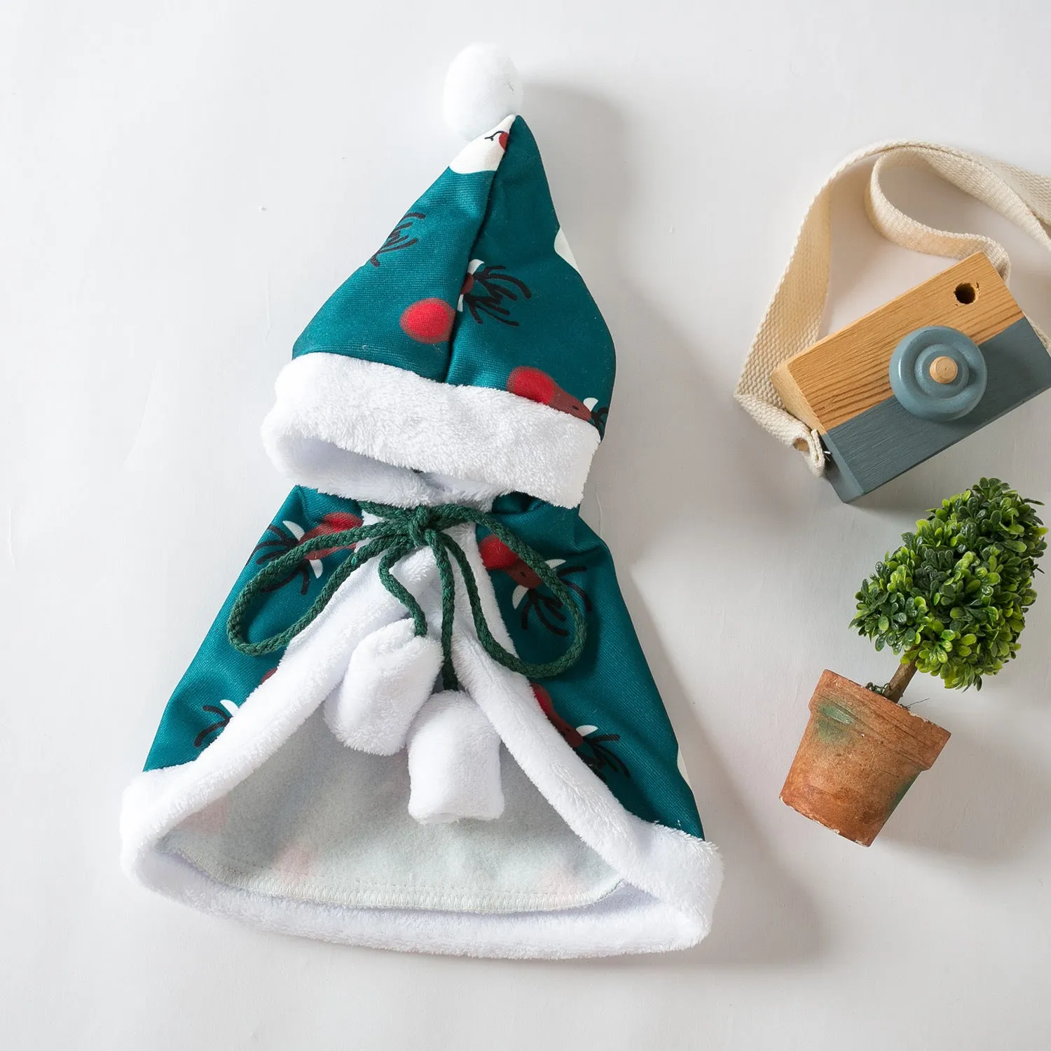 Red deer-print Christmas cloak cape on a cat, showing Little Red Riding Hood style.