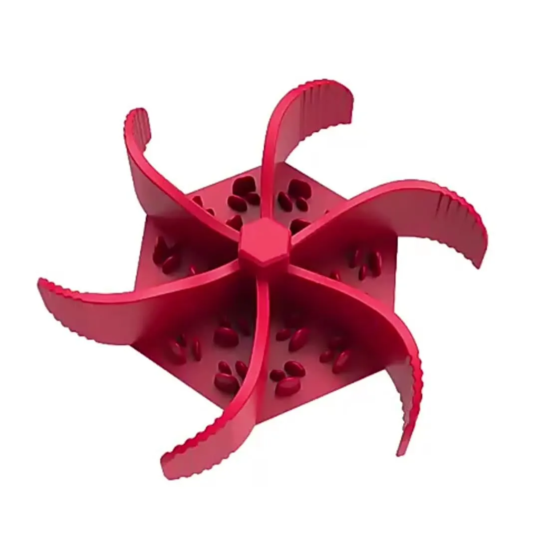 Silicone pet slow food device with sucker cup in green colour on a smooth floor
