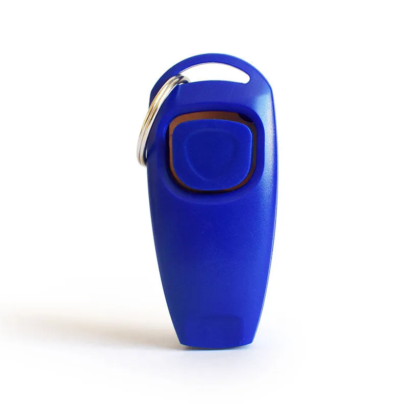 Pet training clicker and whistle set with key ring in orange, white, and blue plastic on a wooden table