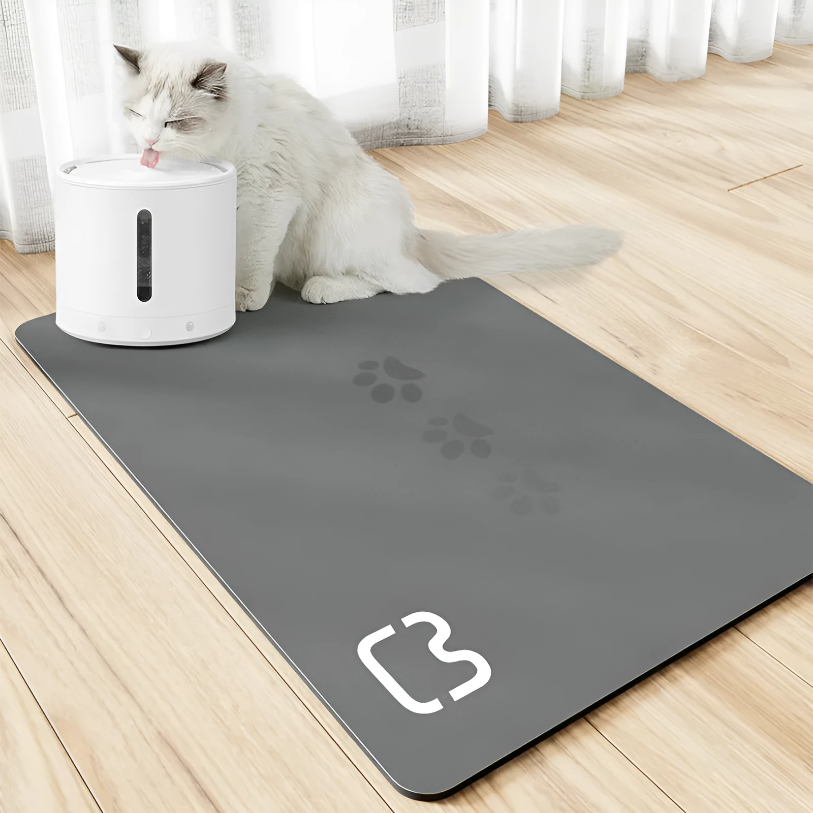 Pet feeding mat with non-slip backing in a dog paw print design on a hardwood floor.
