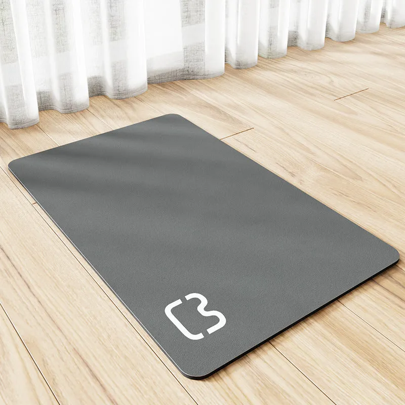 Pet feeding mat with non-slip backing in a dog paw print design on a hardwood floor.