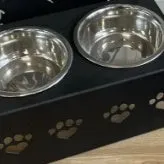 Personalised wrought iron dog bowl rack with custom name, 33x17x7cm, holding a metal dog bowl