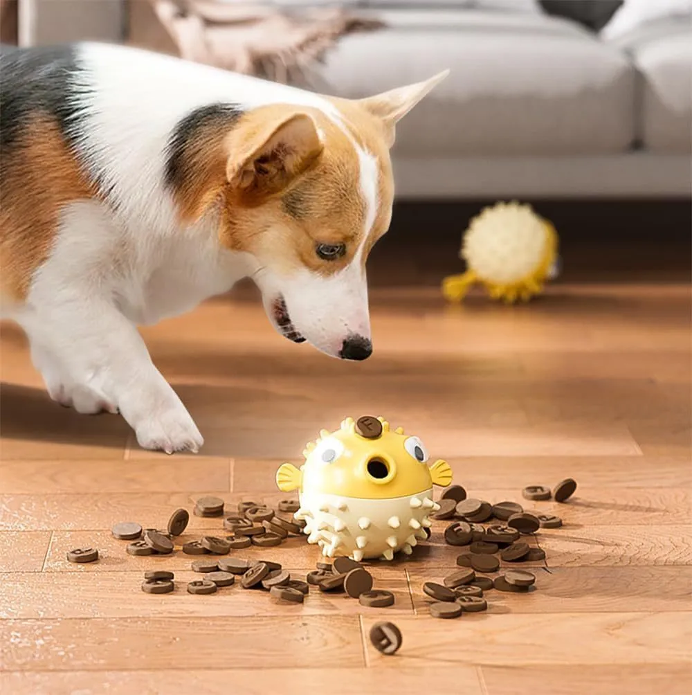 Green fish-shaped interactive dog toy with textured surface and treat dispensing opening