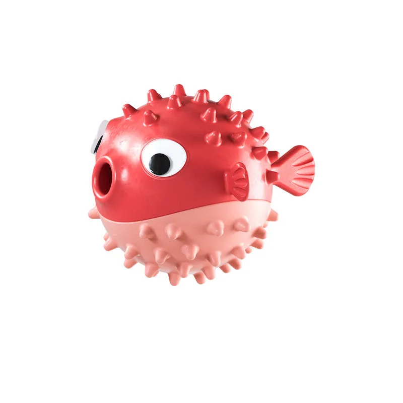 Green fish-shaped interactive dog toy with textured surface and treat dispensing opening