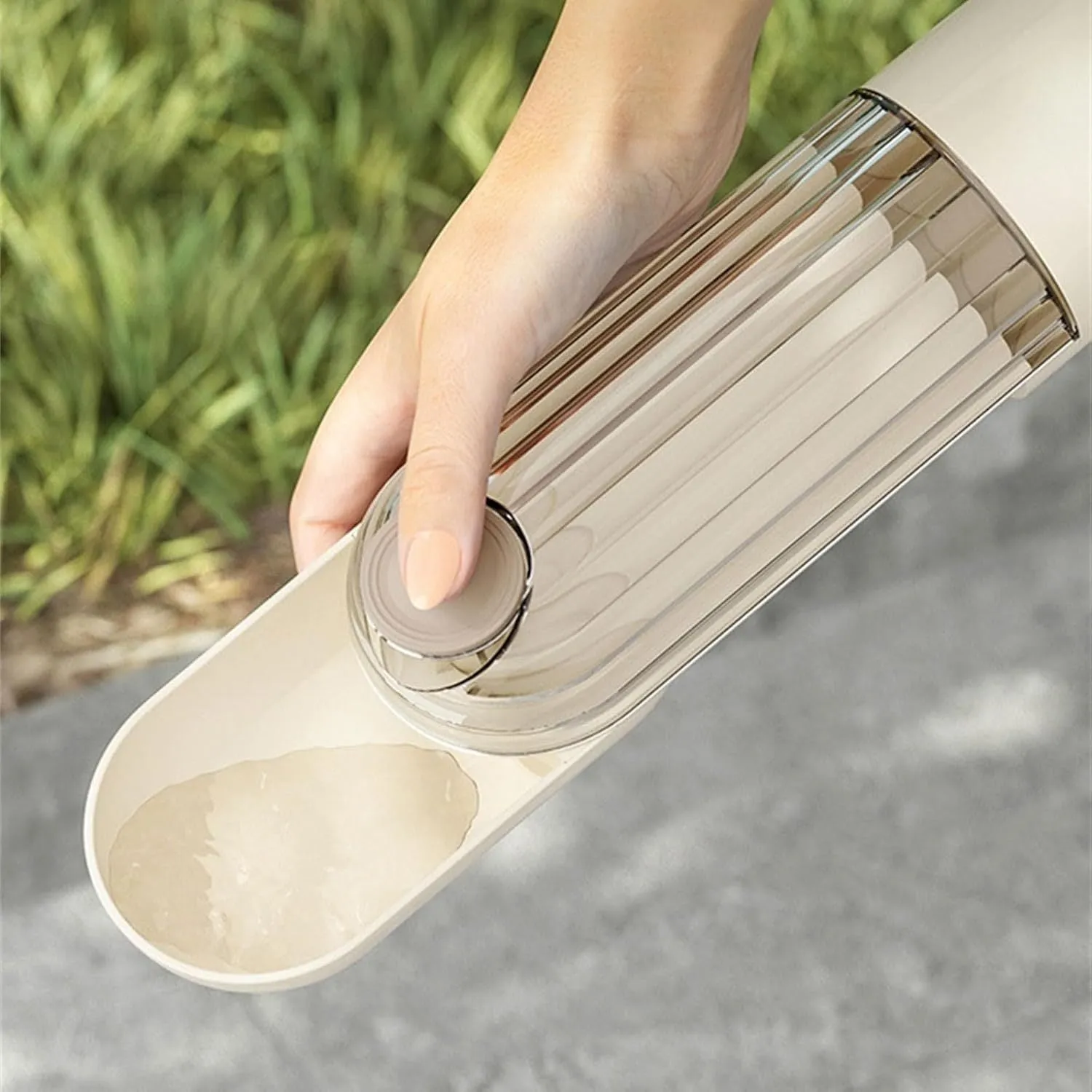Beige foldable dog water bottle and food dispenser with press mechanism, shown next to a green version.
