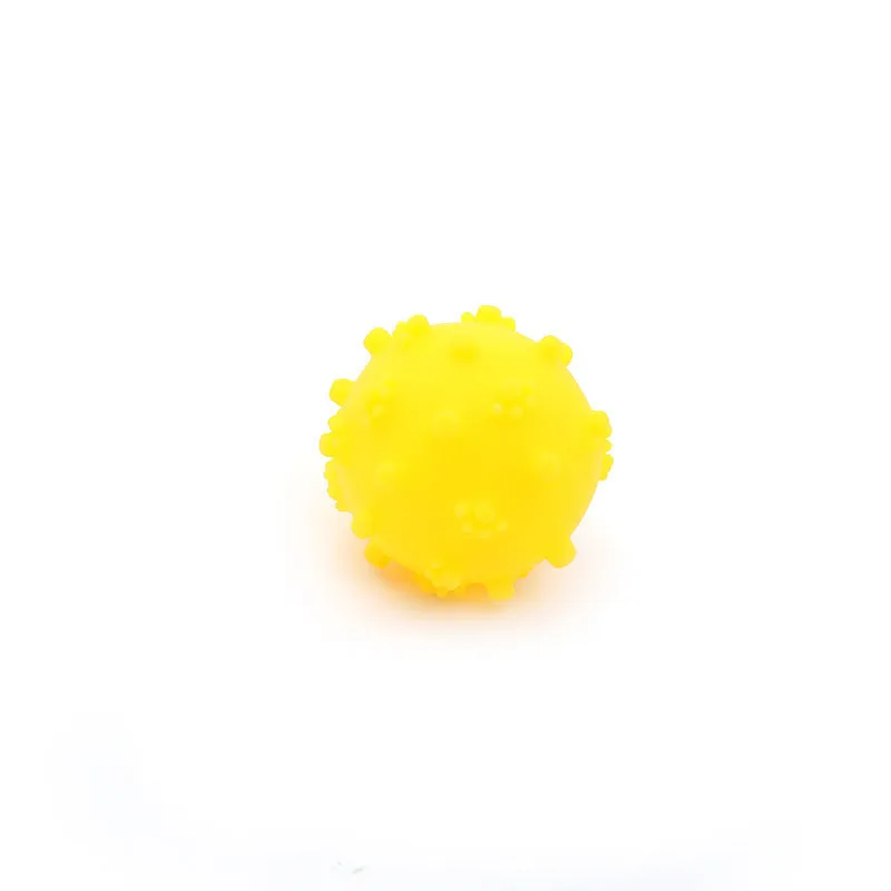 Bright blue, green, pink, and yellow squeaky dog toy balls with a spiky texture and paw print dimples.