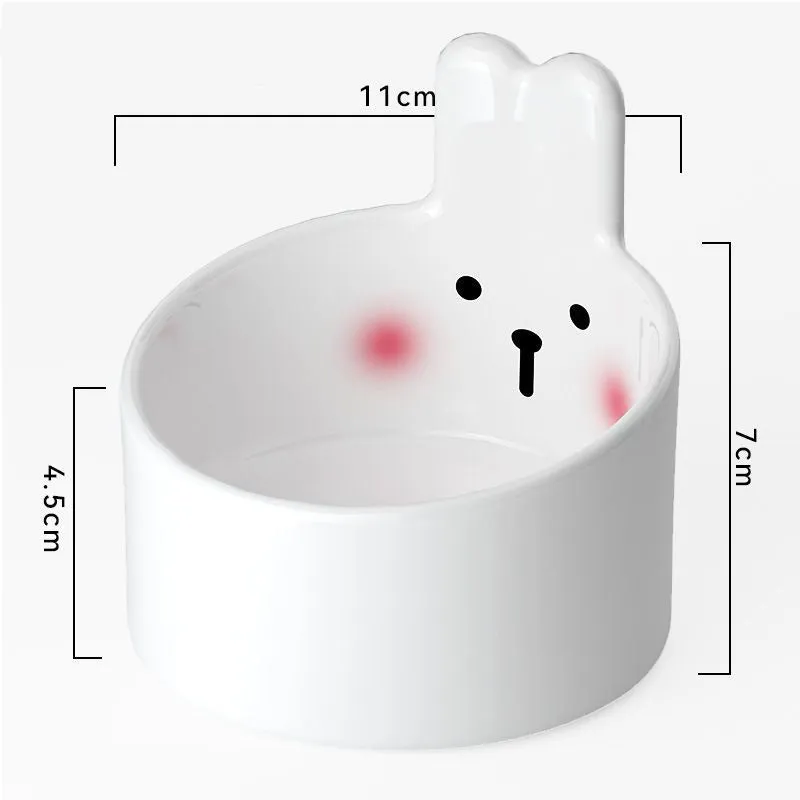 White ceramic pet food bowl with slant design on a plain surface