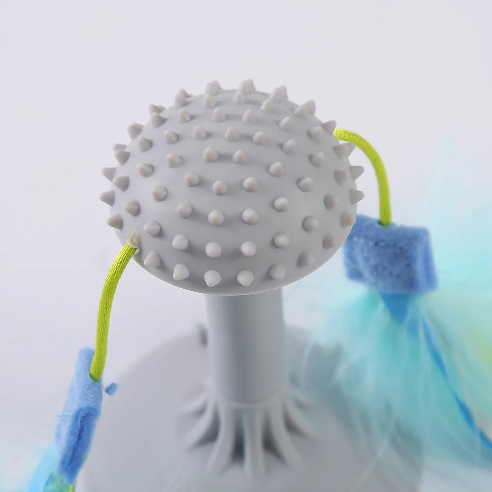 Blue cat toy wand with double haired prick head and suction cup base on a window