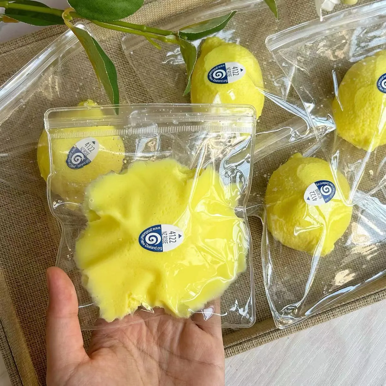 Yellow silicone lemon squeezing toy on a flat surface used for stress relief and sensory play