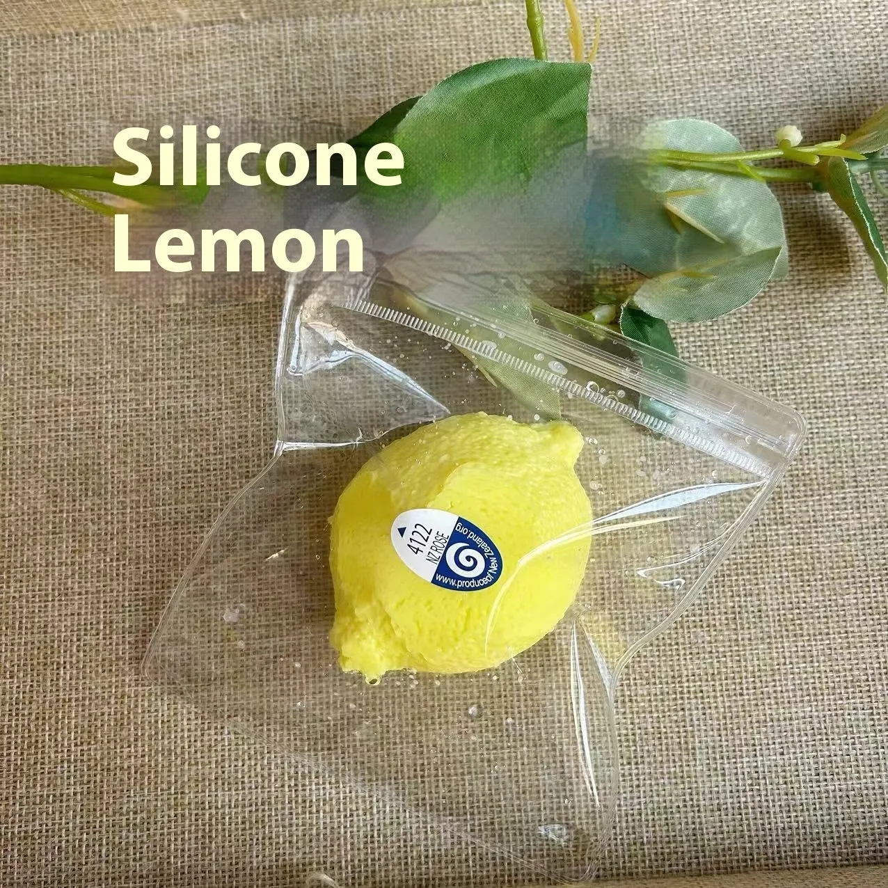 Yellow silicone lemon squeezing toy on a flat surface used for stress relief and sensory play