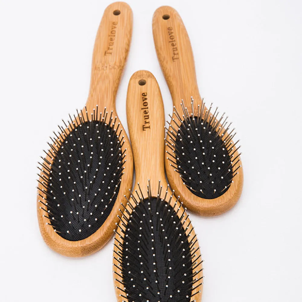 Medium pet deshedding comb with bamboo handle and stainless steel needles in original bamboo colour on a flat surface