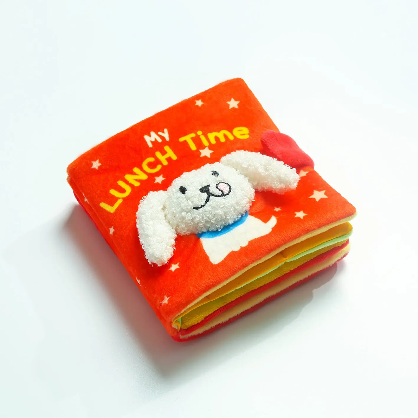 Red book shaped plush pet toy with hidden food compartment and squeaky sound for dogs and cats