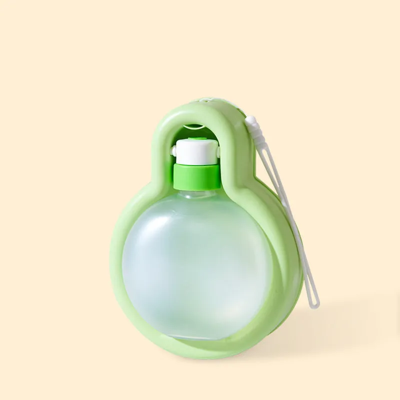 Green portable dog water bottle with integrated drinking bowl for travel and outdoor use