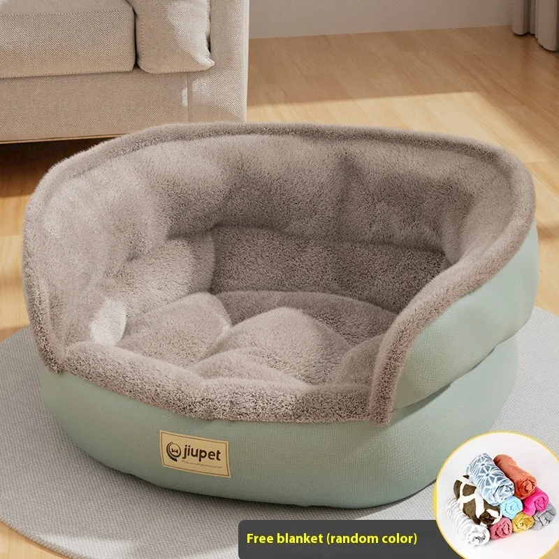Green cloth sofa-style dog kennel with matching blanket, size M, on a wooden floor