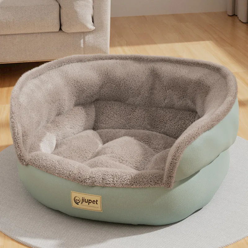 Green cloth sofa-style dog kennel with matching blanket, size M, on a wooden floor