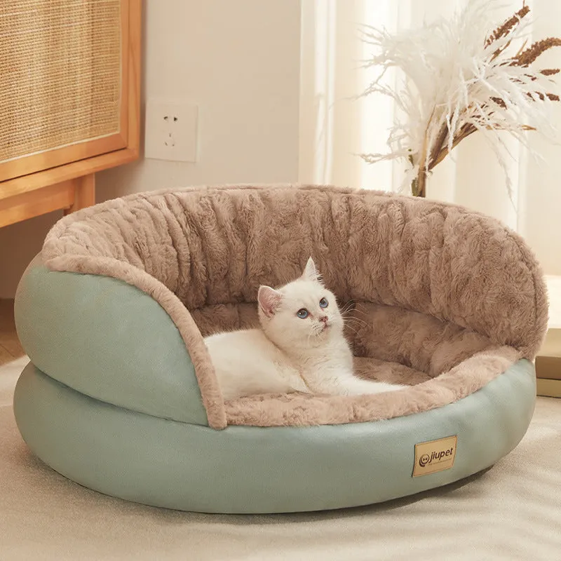 Green cloth sofa-style dog kennel with matching blanket, size M, on a wooden floor