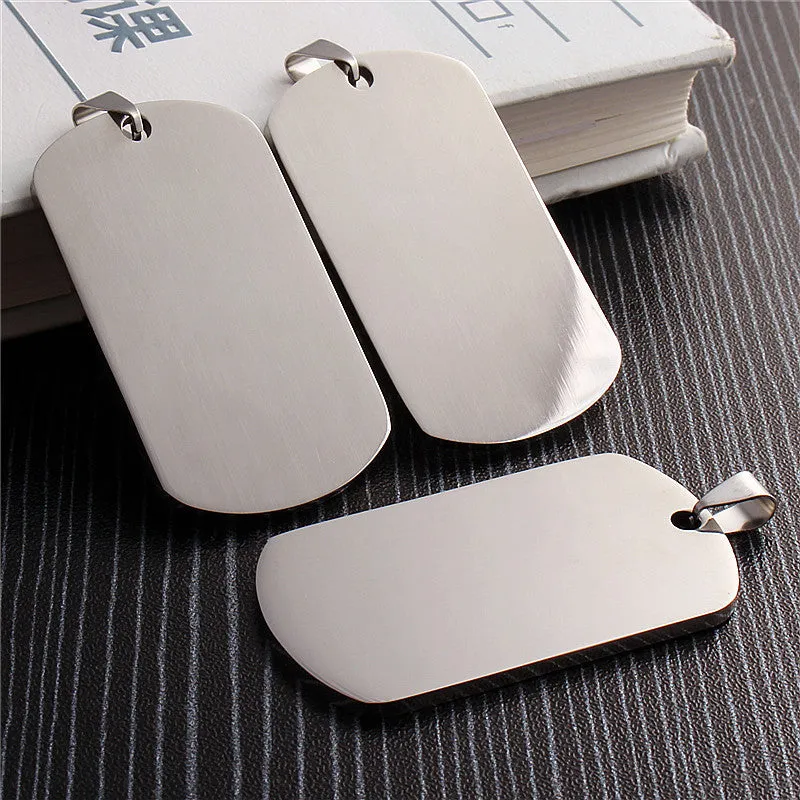 Stainless steel dog tag pendant with polished finish, 50x29mm, and silencing ring attached