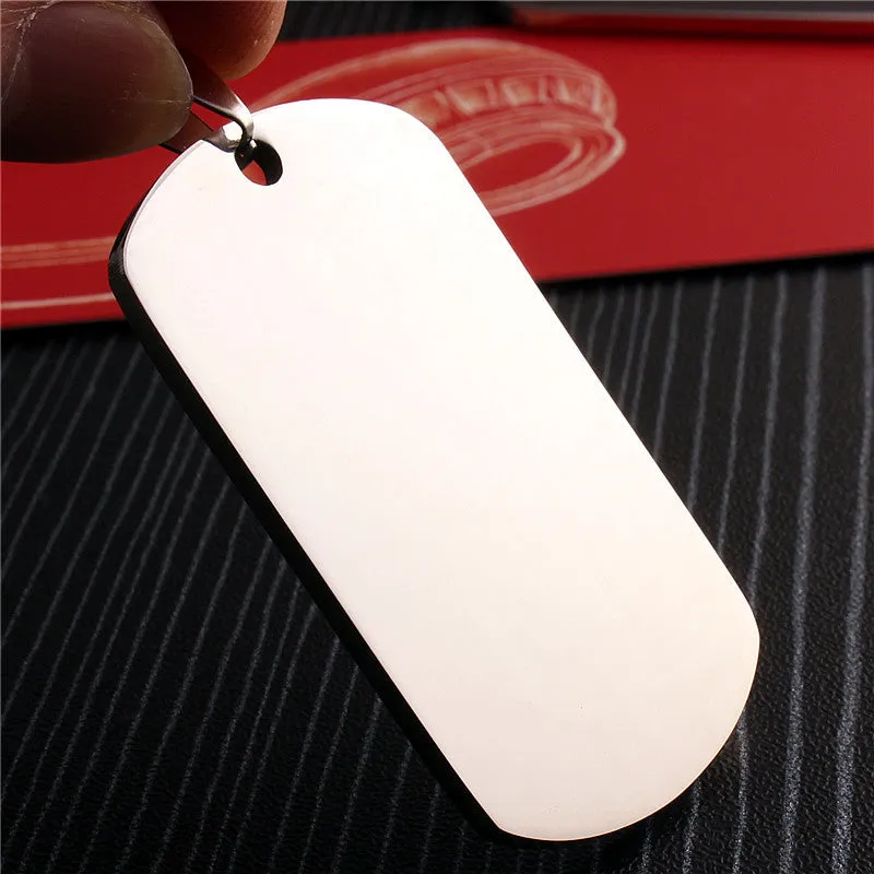 Stainless steel dog tag pendant with polished finish, 50x29mm, and silencing ring attached