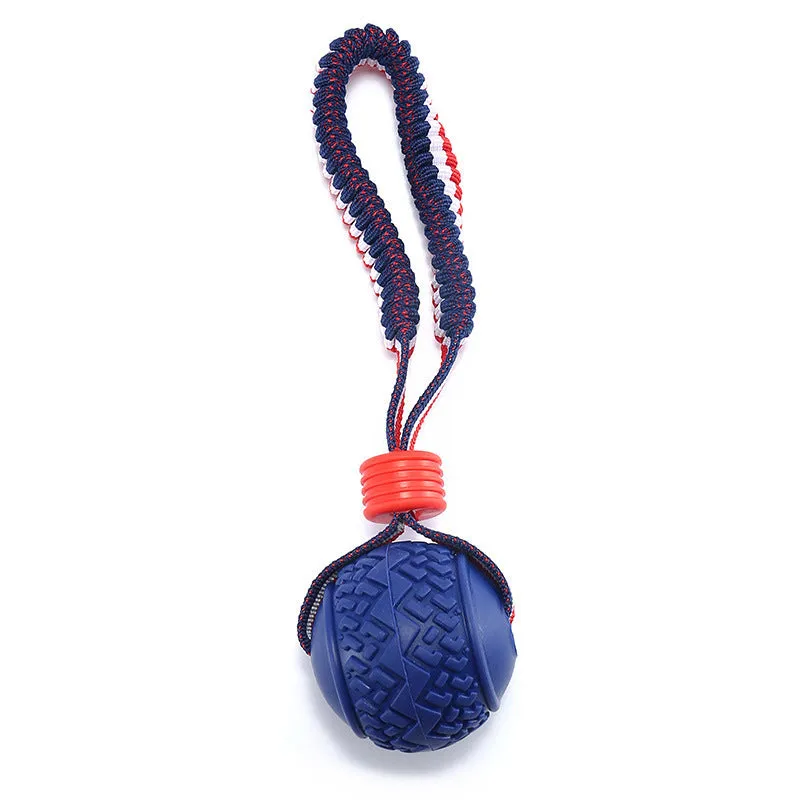 Blue rubber dog ball with rope attachment for tug-of-war and teeth cleaning
