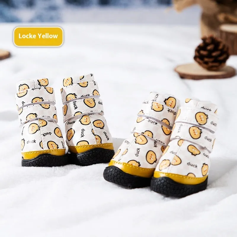 Fleece-lined waterproof dog boots in yellow with non-slip rubber sole on a wooden floor